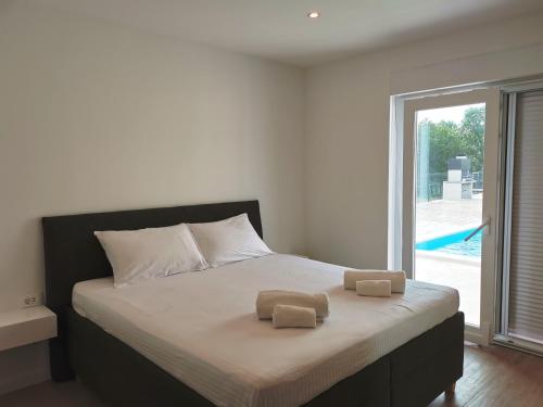 乌马格Villa Mare e Monti with heated pool的一间卧室配有一张床,上面有两条毛巾