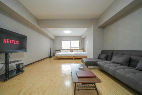 札幌Residence Hotel KABUTO的带沙发和电视的客厅