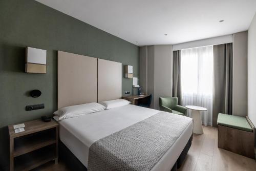 巴塞罗那加泰罗尼亚阿尔贝尼兹酒店的卧室配有白色的床和绿色的墙壁