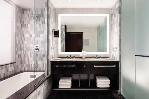 洛杉矶洛杉矶活力洛城丽思卡尔顿酒店的一间带水槽、浴缸和镜子的浴室