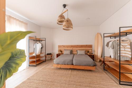 大里贝拉Eco Surflodge Azores的一间卧室配有一张床和一个冲浪板