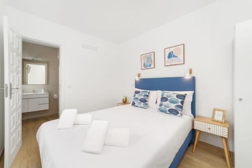纳扎雷Pátio C'un Casinhas的白色卧室配有蓝色和白色的床