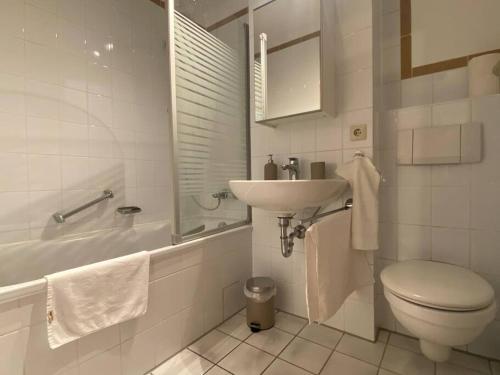普福尔茨海姆Hübsche Wohnung mit Balkon für 1-2 Personen - Einzelbetten的白色的浴室设有水槽和卫生间。