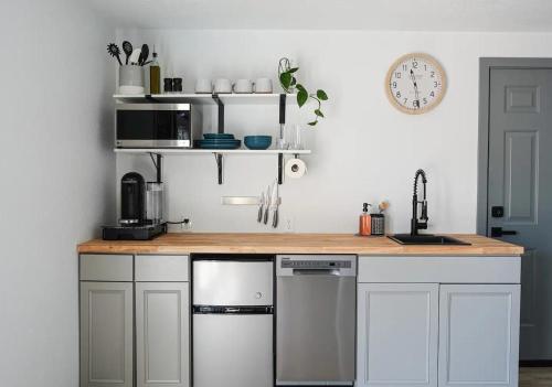 斯普林菲尔德Northbank Loft的厨房配有白色橱柜和木制台面