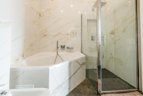芒通Villa Daniel的带淋浴、浴缸和盥洗盆的浴室