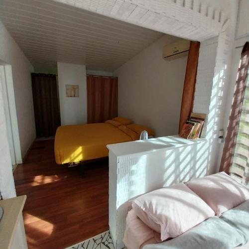 MahinaPacific Lodge的一间卧室配有一张黄色毯子床