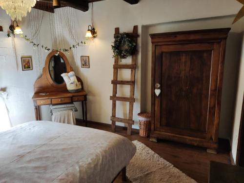 帕莱斯潘蒂雷蒙Feggaropetra Inn Magic Mountain House的一间卧室配有一张床、镜子和木门