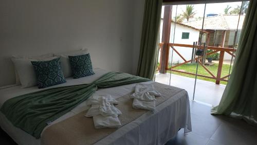 戈亚斯州上帕莱索POUSADA ACONCHEGO CHAPADA的一间卧室配有带毛巾的床