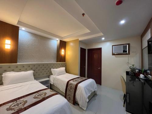 土格加劳Hotel Erich的酒店客房设有两张床和电视。