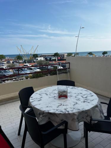 帕拉瓦莱弗洛RAINIE APPART的阳台的桌子享有码头的景致