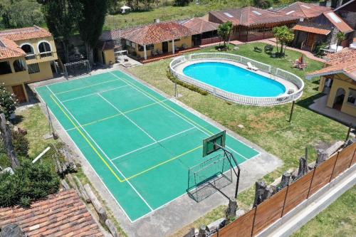 昆卡Quinta San Martín的房屋前网球场的顶部景色