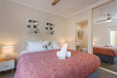 珀斯Casa Toucan - 2 bedroom apartment close to the airport的一间卧室配有一张床和镜子