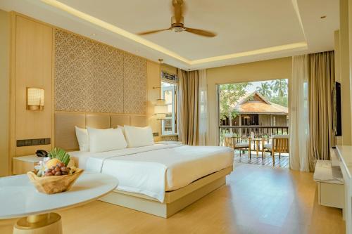 珍南海滩Pelangi Beach Resort & Spa, Langkawi的一间卧室设有一张床和一个阳台