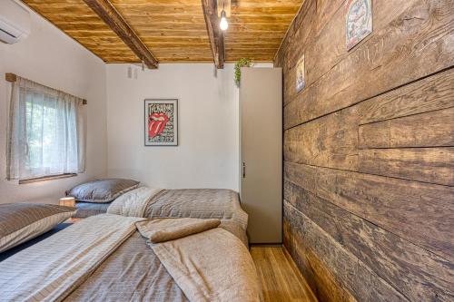 亚斯特雷巴斯科Holiday Home Carpe Diem的配有两张床铺的客房设有大型木墙