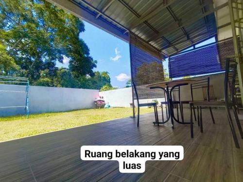 Hmsty D Hutan Kampung Alor Setar (Muslim)的铺有木地板的庭院配有桌椅