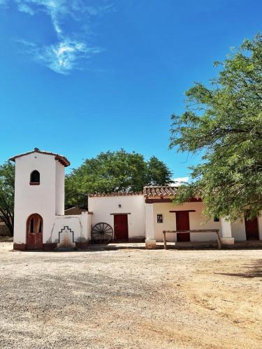 圣卡洛斯La Vaca Tranquila的前面有一棵树的白色小建筑