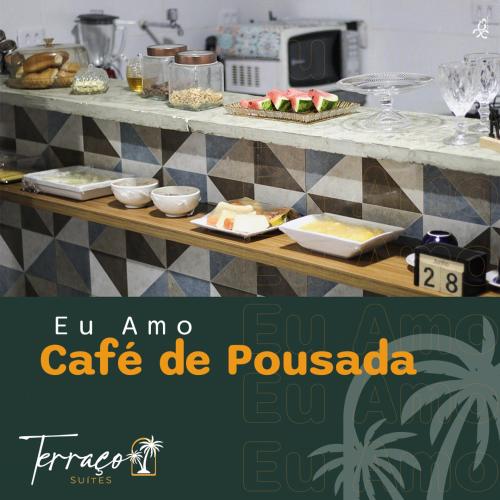乌尼昂-杜斯帕尔马里斯Hotel Terraço Suítes的餐桌上放有食物盘子的桌子