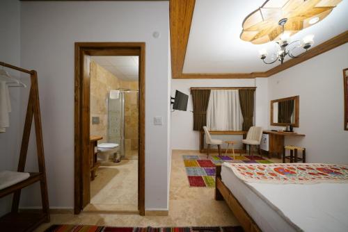 格雷梅Pashahan Hotel的一间卧室设有一张床和一间浴室。