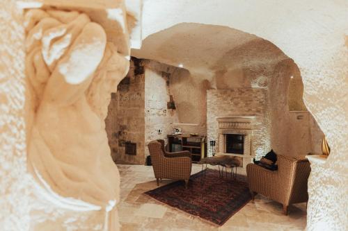 乌奇希萨尔Harem Suites Cappadocia的带壁炉的客厅内的雕像