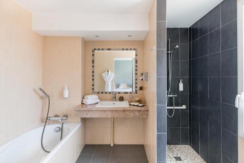 布鲁良普拉斯诺威酒店的带浴缸、水槽和淋浴的浴室