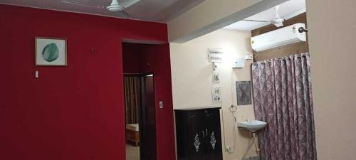 巴特那Ananya Homestay的一间带红色墙壁和卫生间的浴室