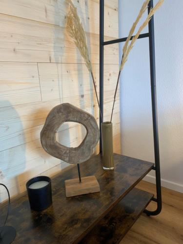 上施陶芬Staufen Herz的木桌上的金属雕塑,带花瓶