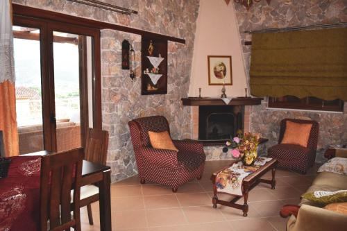 Rose Garden Villa的客厅配有两把椅子和壁炉