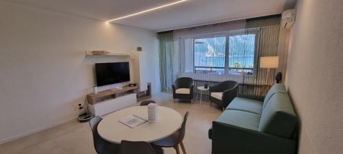 比索内Relax-Lugano Lake的客厅配有沙发和桌子