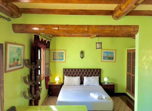泰夫劳特雷尔葛妮尔迪迈尔酒店的一间卧室设有一张带绿色墙壁的大床
