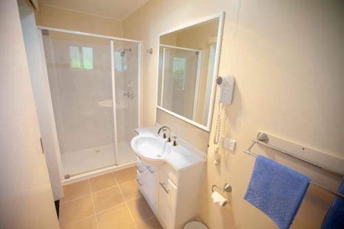 MitchellMitchell Motel & Cabin Park的白色的浴室设有水槽和淋浴。