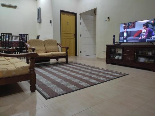 Pasir MasMegat Homestay的带沙发和电视的客厅