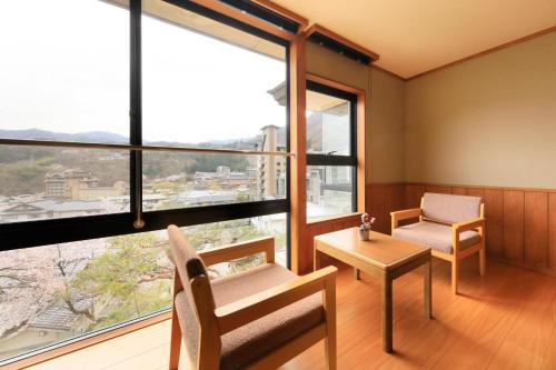 Hirugami日長庵 桂月的客房设有椅子、桌子和窗户。