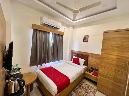古瓦哈提AIR VALLEY INN的一间卧室设有一张床和一个窗口