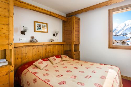 土绪尔Lagrange Vacances L'Ecrin des Sybelles的一间卧室设有一张床和一个窗口