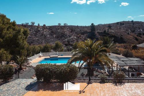 普埃尔托伦夫雷拉斯罗斯塞比利斯酒店的一座棕榈树和山的游泳池