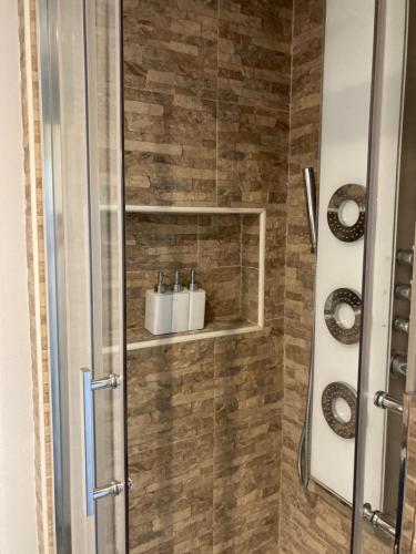 第戎Appartement cosy的带淋浴的浴室和玻璃门