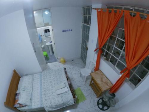 纳斯卡Nanasqa Hostel en Nasca / Nazca的卧室的顶部景色,卧室配有橙色窗帘