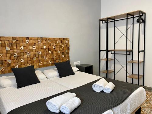 罗塔Anka Kurro by Bossh Hotels的一间卧室配有一张大床和毛巾
