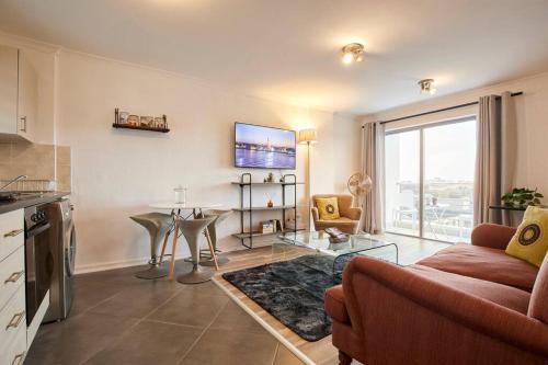开普敦Rondebosch Central的客厅配有沙发和桌子
