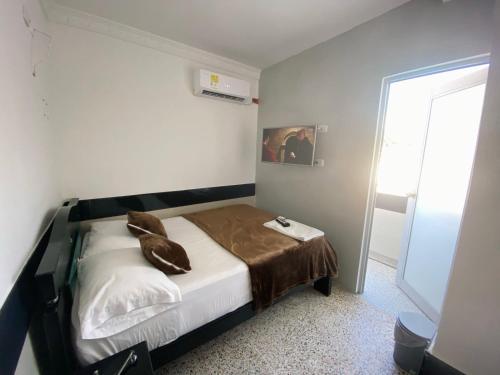 阿瓜奇卡HOTEL IMPERIAL LA QUINTA的一间卧室配有一张带棕色毯子的床