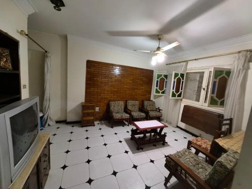 伊斯梅利亚Rental home ismailia的客厅配有电视、椅子和桌子