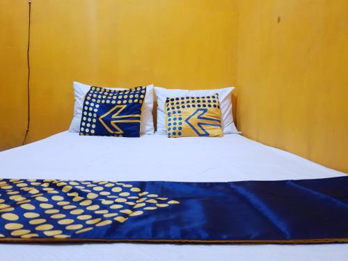 外南梦SPOT ON 92857 Kos Haji Jakfar Syariah的一张带蓝色和白色床单及枕头的床