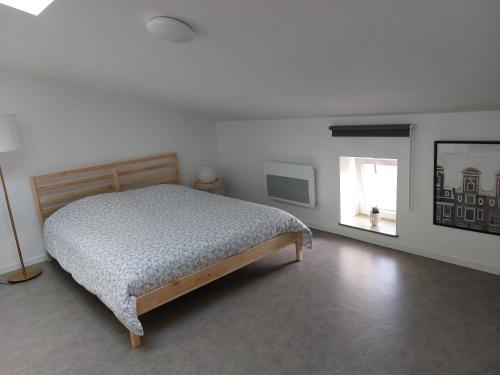 Corny-sur-MoselleStudio mezzanine tout confort的一间卧室设有一张床和一个窗口