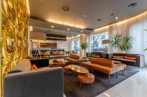 里斯本萨尔达尼亚酒店的一个带沙发和桌子的大堂和一间酒吧
