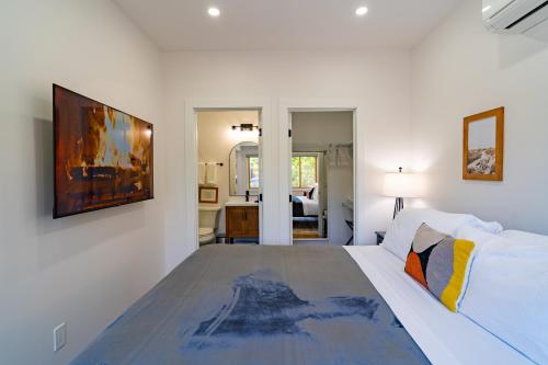 圣地亚哥Fern House South Park Craftsman的白色卧室配有一张床,墙上挂着一幅画