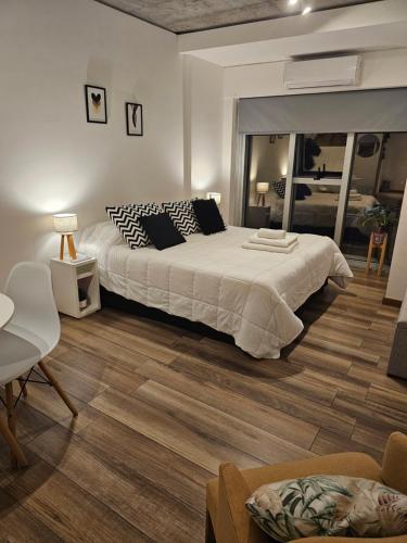 布宜诺斯艾利斯Belgrano BLUE Apartment的一间卧室设有一张大床,铺有木地板