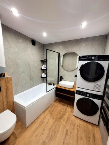 齐斯纳Apartament Wrzos的浴室配有白色的浴缸和微波炉。