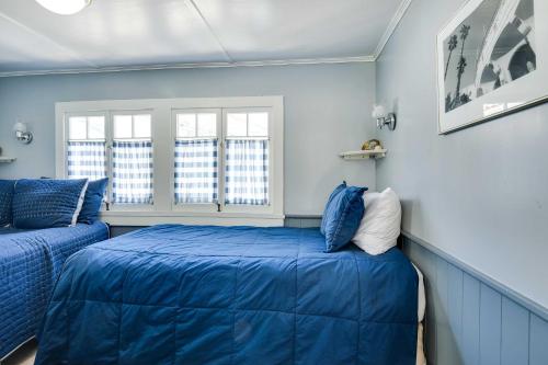 阿瓦隆Charming Catalina Gem with Deck Walk to the Beach!的蓝色的客房设有两张床和两个窗户。