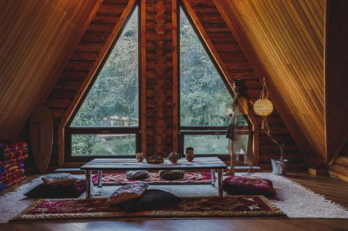 阿拉木图Sabay Sai Wooden Guesthouse in The National Park的一间设有一张桌子的房间,位于大窗户前