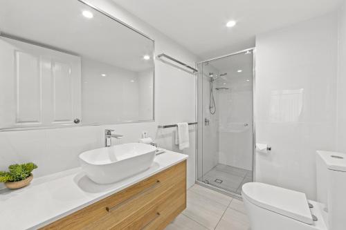 穆卢拉巴纽波特穆卢拉巴公寓的白色的浴室设有水槽和淋浴。